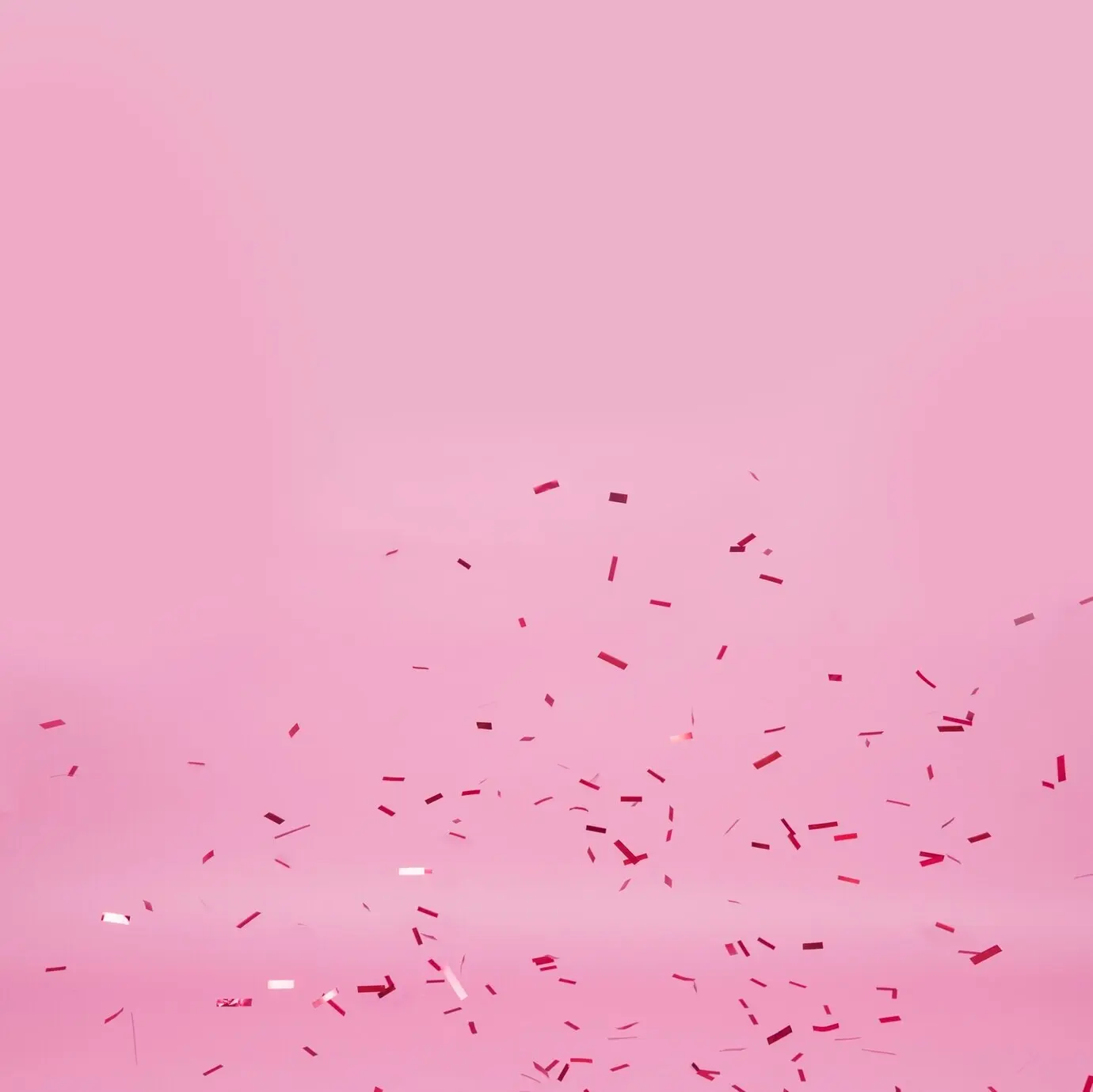 Dunkles Konfetti auf pinkem Hintergrund